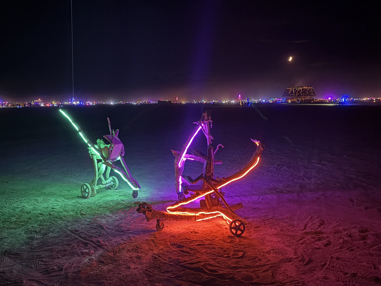 Klajdi's illuminated stroller art on the playa at night